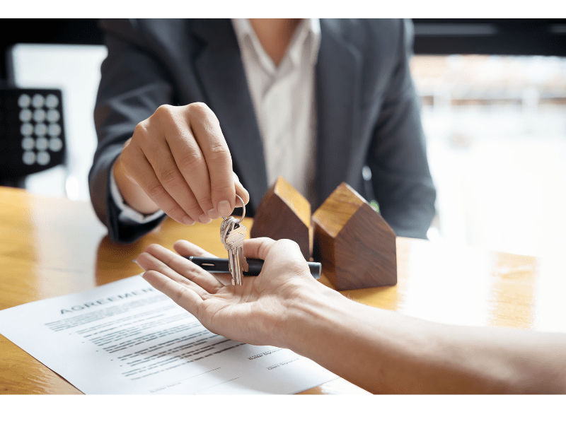 Realtor Handing Over Keys to Home Owner