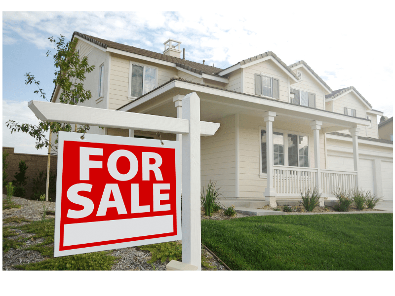 For Sale Sign in Front of House